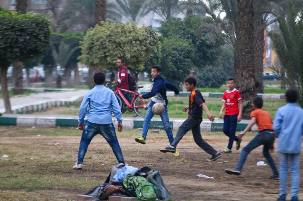 
									Boys Playing Soccer in a Park, Cairo Winter 2017