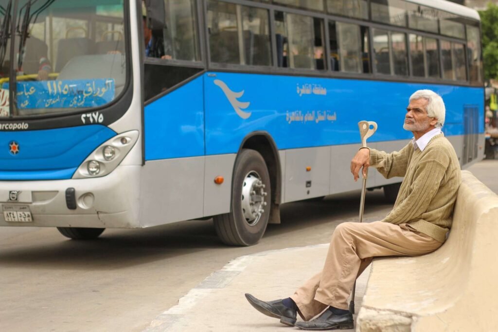 Man Sitting at Bus Station in Abbassia, Cairo, Holding a Cane 3