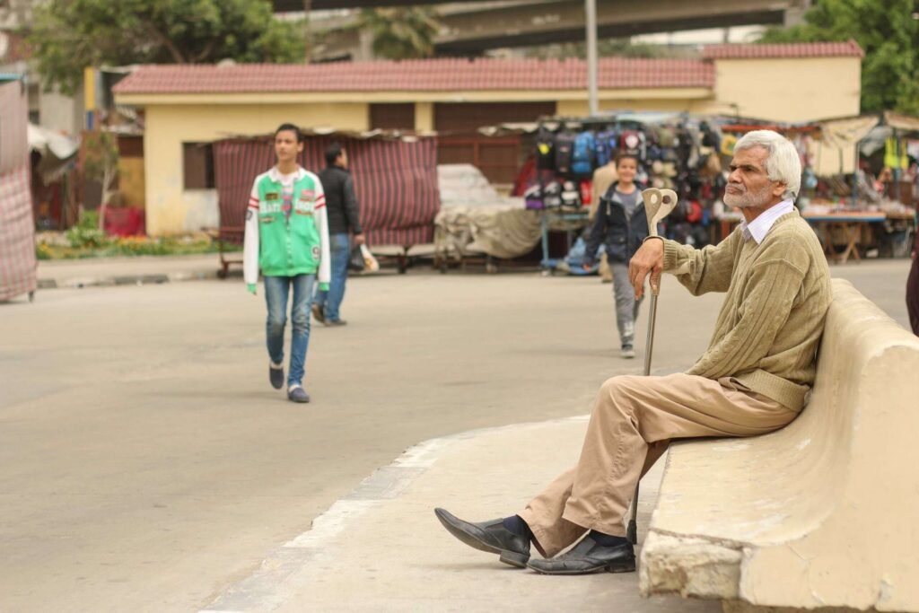 Man Sitting at Bus Station in Abbassia, Cairo, Holding a Cane 2