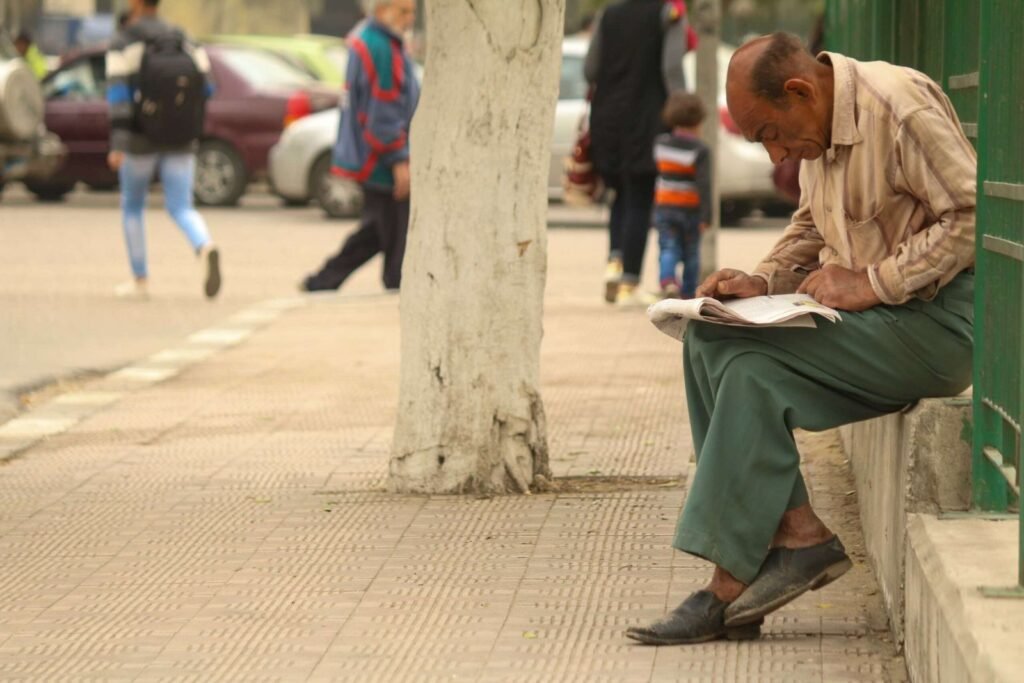 Man Reading a Newspaper in a Street in Cairo