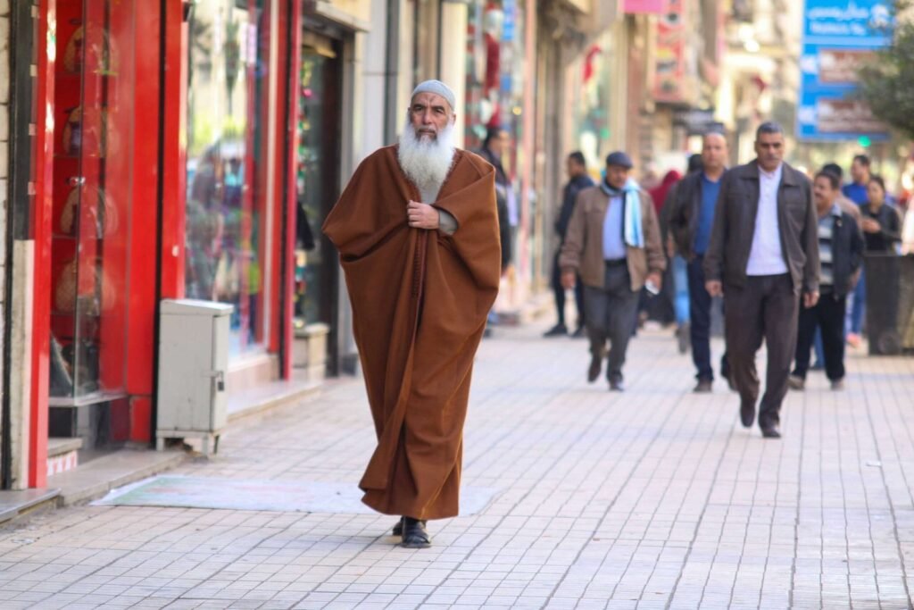 Elderly Man Walking on Busy Sidewalk – Cairo Winter 2017