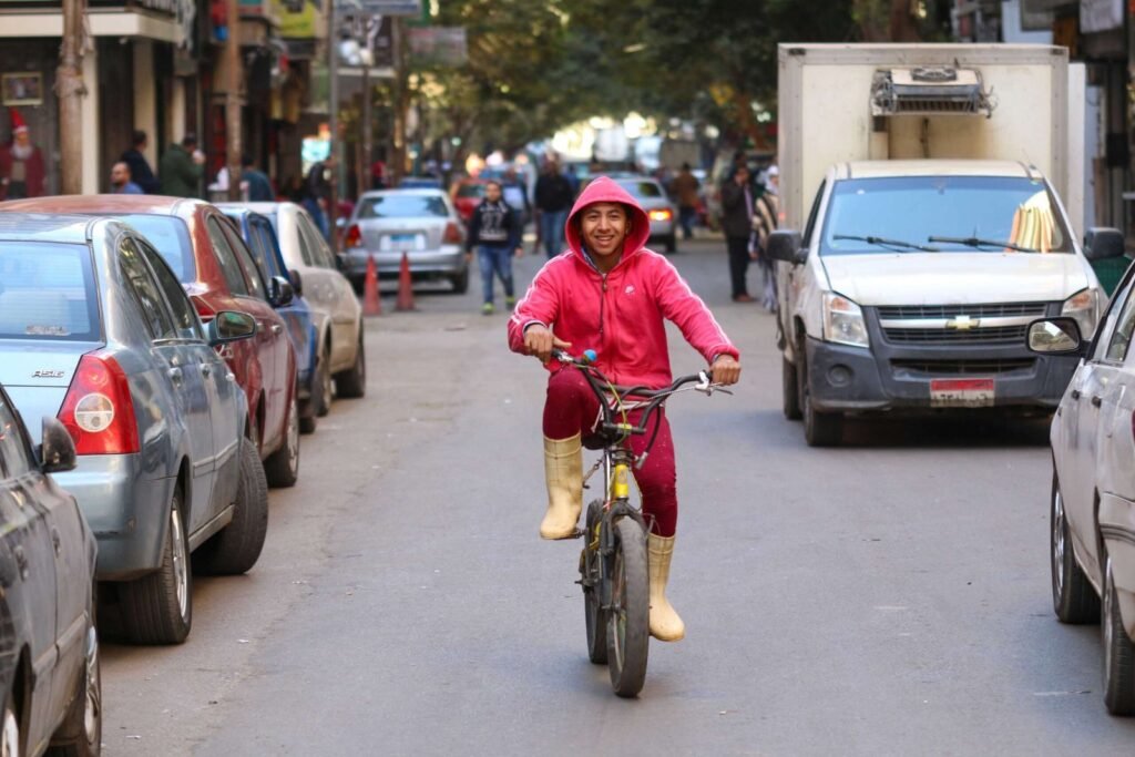 Smiling Cyclist in Red Hoodie – Cairo Winter 2017