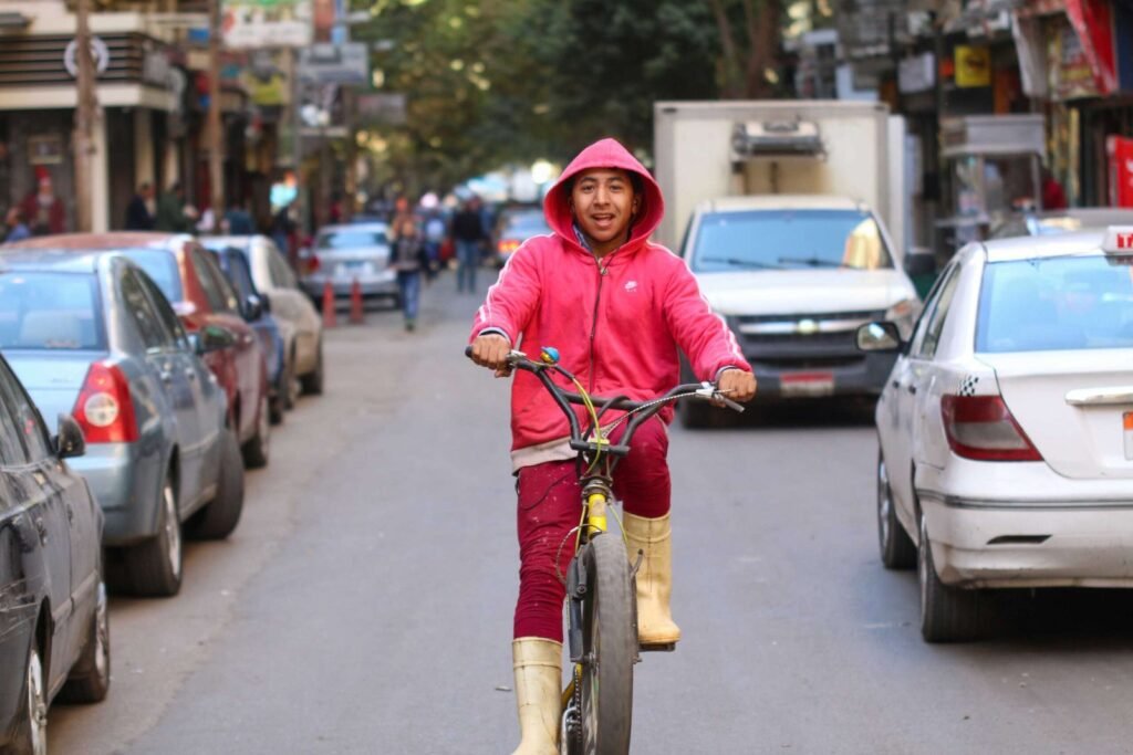 Smiling Cyclist in Red Hoodie – Cairo Winter 2017