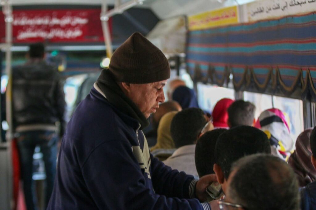 Middle-aged Man Standing on a Bus in Cairo