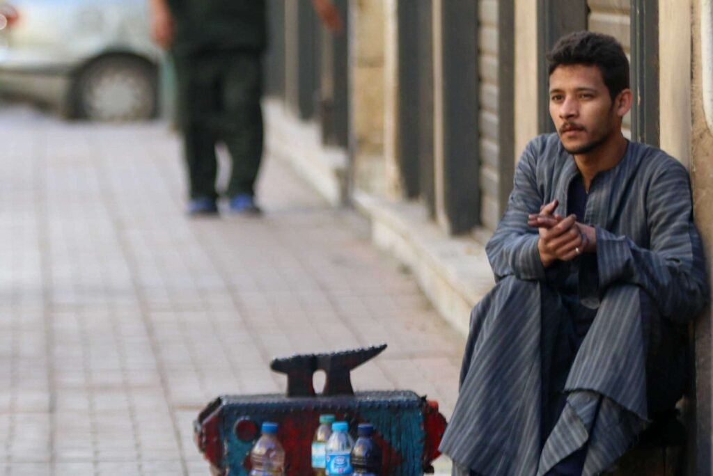 Shoeshiner Waiting for Customers on Magles El Wozara Street, Downtown Cairo