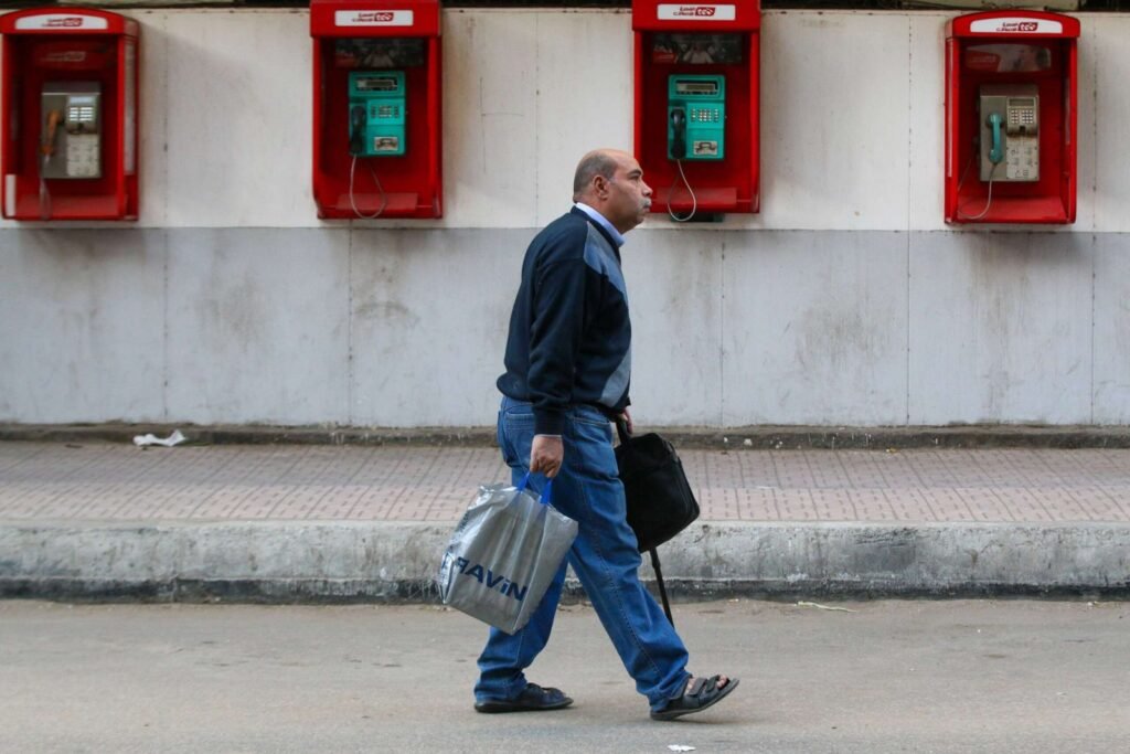Man Walking on Mohamed Mahmoud Street in Front of the Telephone Exchange