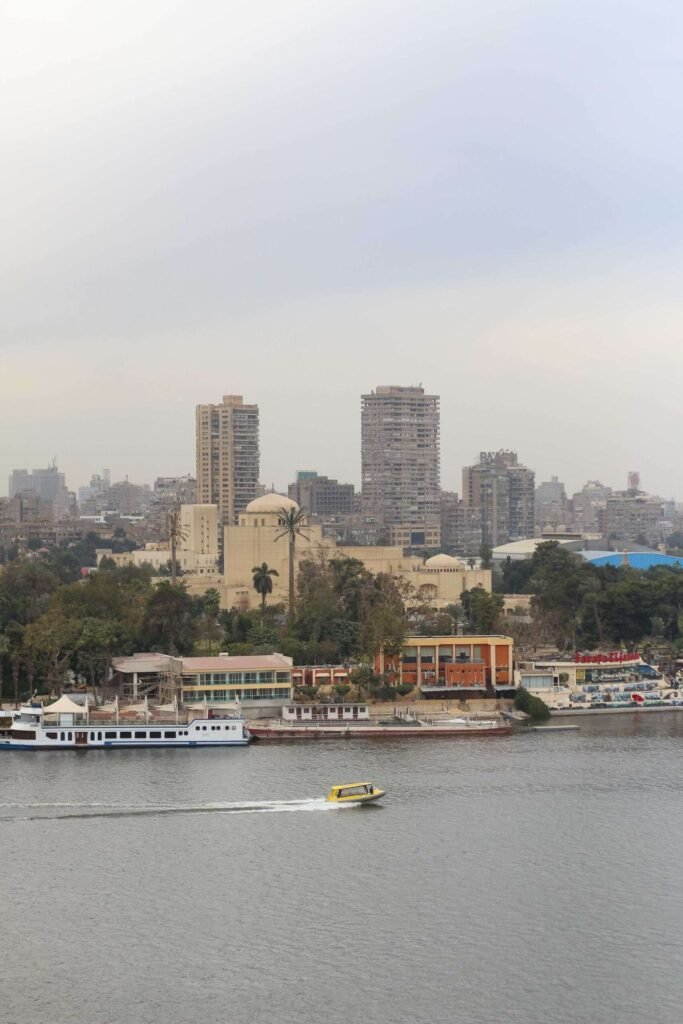 Boat on the Nile with Cloudy Sky, Cairo Skyline, and Cairo Tower