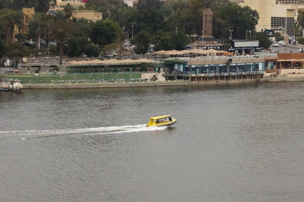 Boat on the Nile with Cloudy Sky, Cairo Skyline, and Cairo Tower