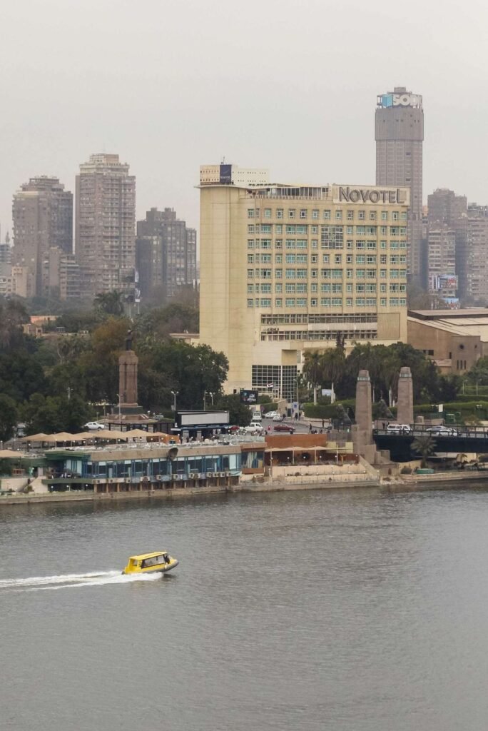 Boat on the Nile with Cloudy Sky, Cairo Skyline, and Cairo Tower