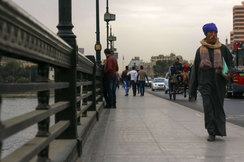 Man in Traditional Attire on Qasr El Nil Bridge in Cairo