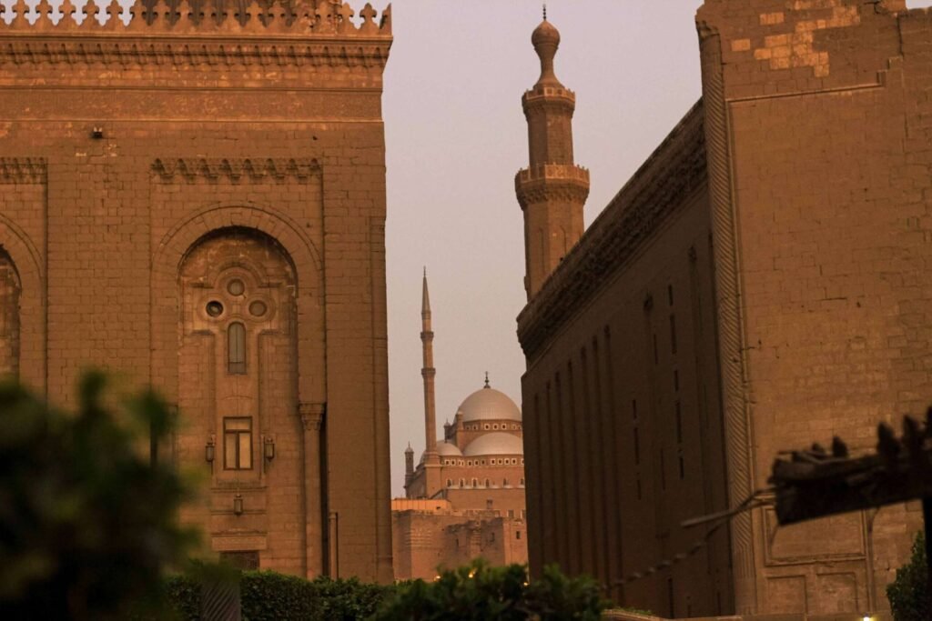 A breathtaking view featuring the Sultan Hassan Mosque and Al-Rifai Mosque, with the iconic dome of the Citadel of Saladin visible in between.