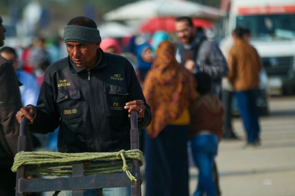 Man Pushing Metal Cart at Cairo International Book Fair – 2017 3