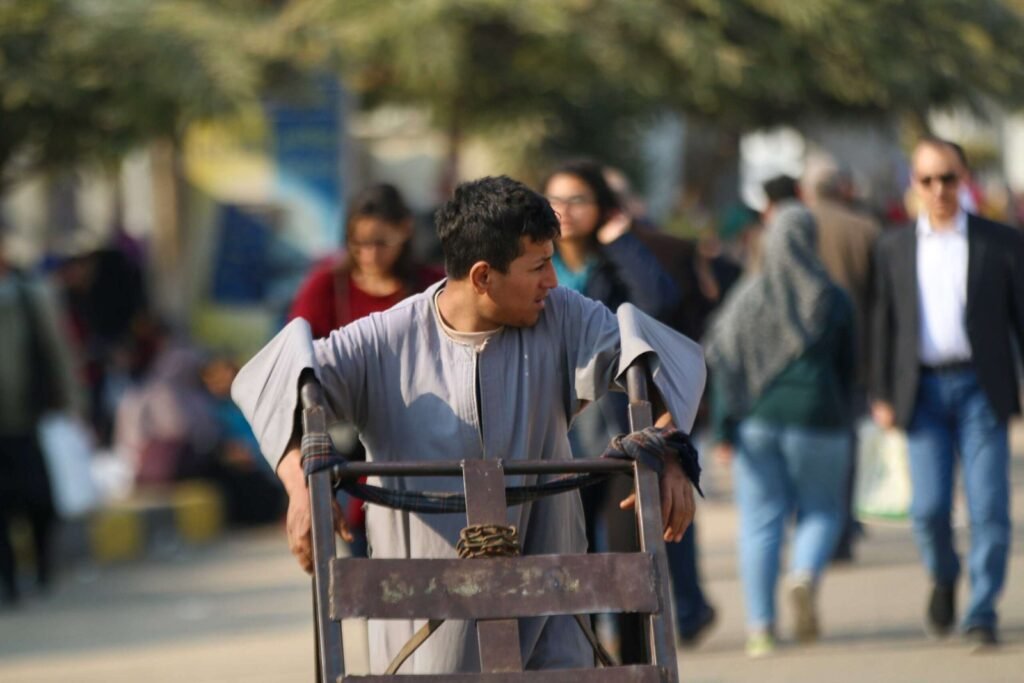 Man Pushing Metal Cart at Cairo International Book Fair – 2017 7