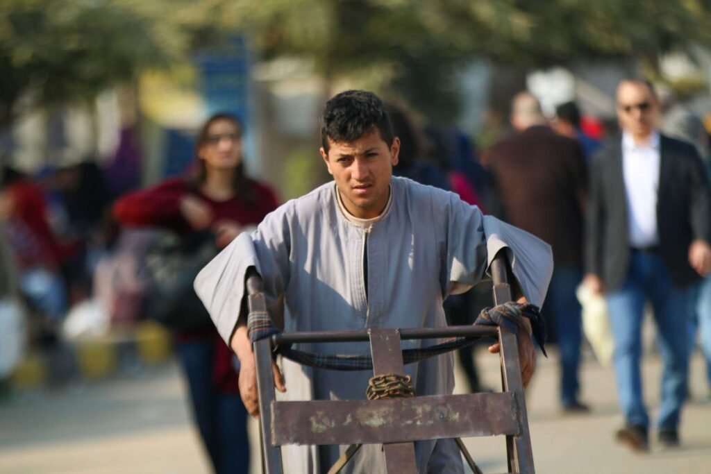 Man Pushing Metal Cart at Cairo International Book Fair – 2017 8