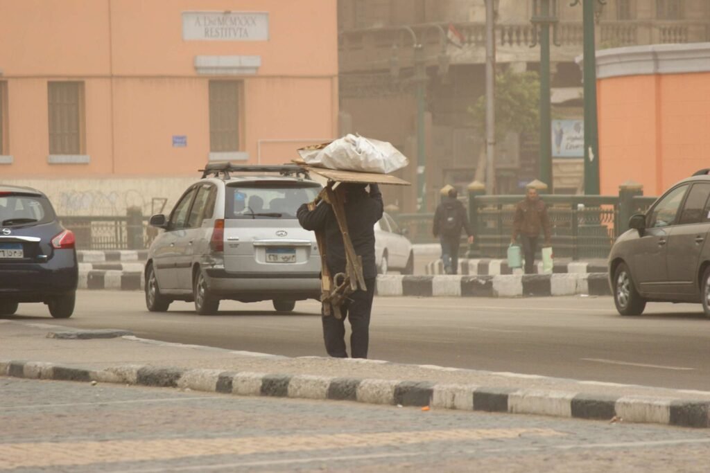 A man carrying his tools in Abdel Moneim Riad Square, Cairo