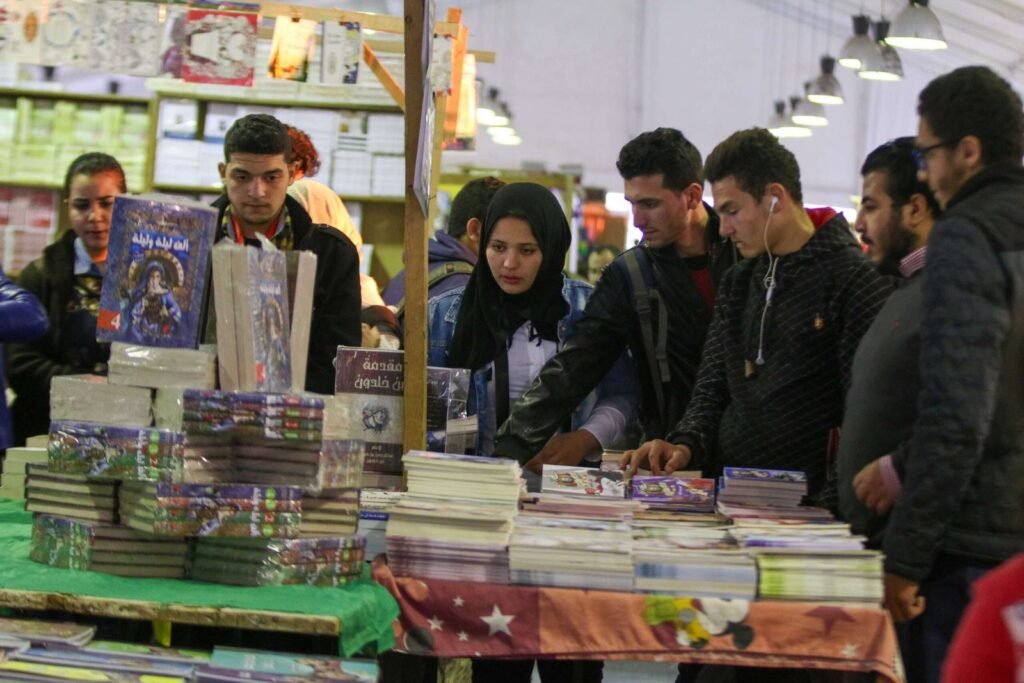 Group of Young People Browsing Books at Cairo International Book Fair – 2017