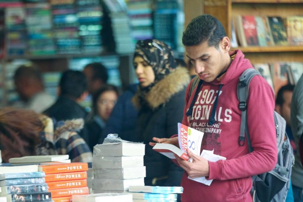 Group of Young People Browsing Books at Cairo International Book Fair – 2017