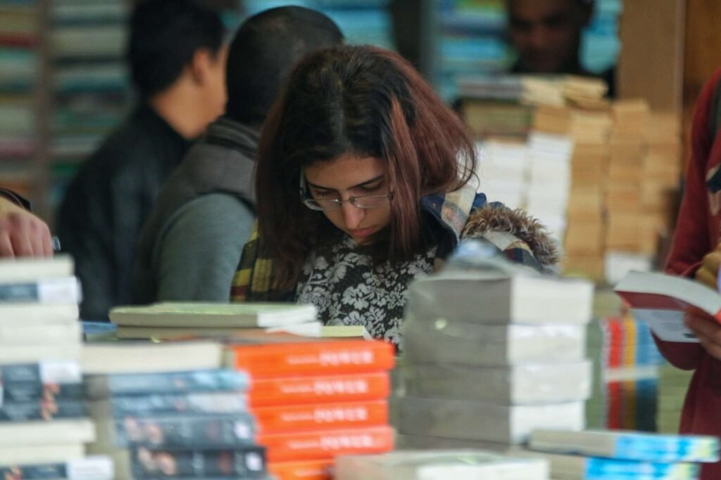 Group of Young People Browsing Books at Cairo International Book Fair – 2017