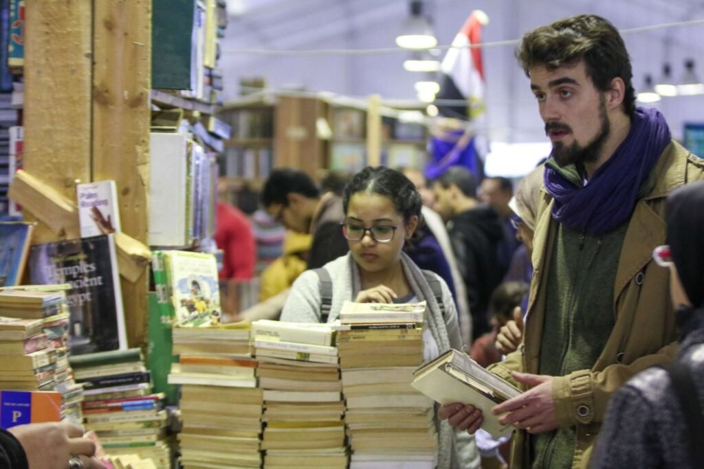 Group of Young People Browsing Books at Cairo International Book Fair – 2017