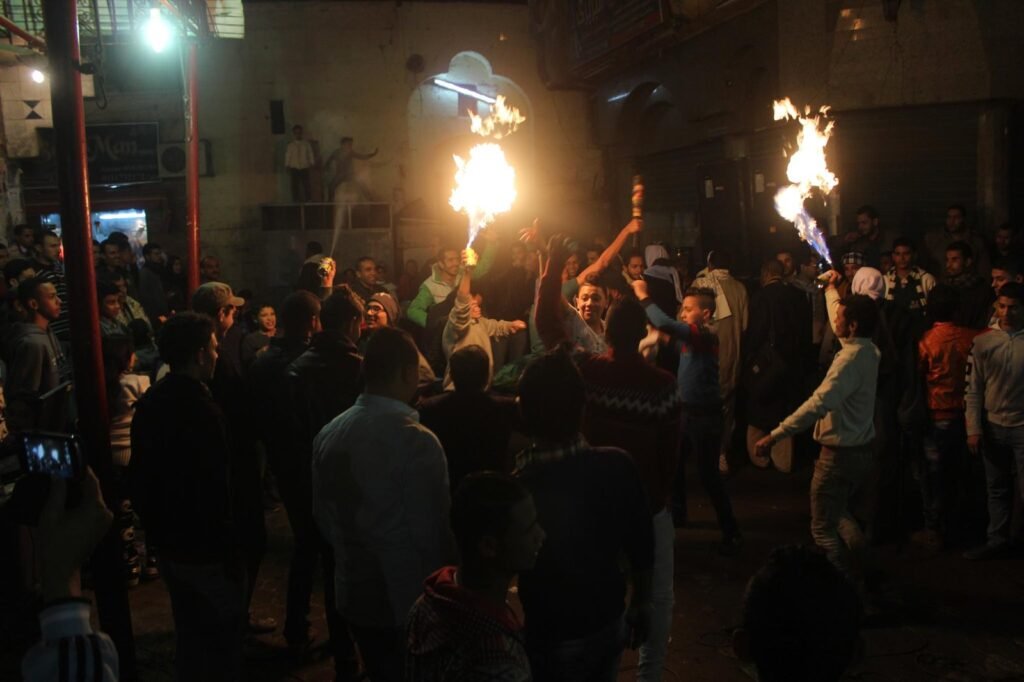 Young Men Performing Fire and Aerosol Spray Dance at Al-Hussein Mawlid – Cairo, Egypt