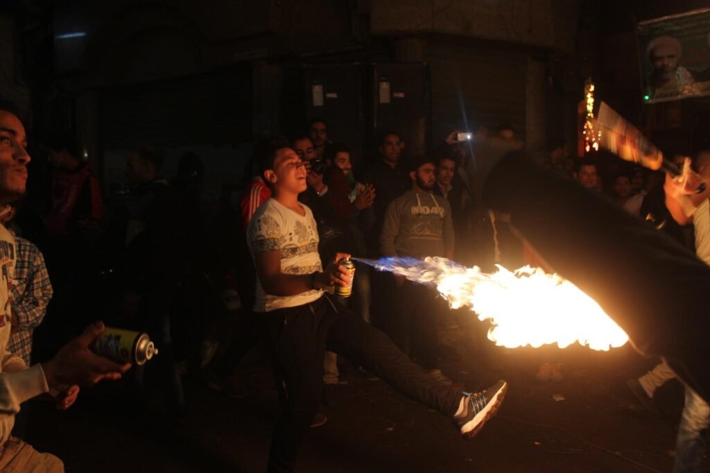 Young Men Performing Fire and Aerosol Spray Dance at Al-Hussein Mawlid – Cairo, Egypt