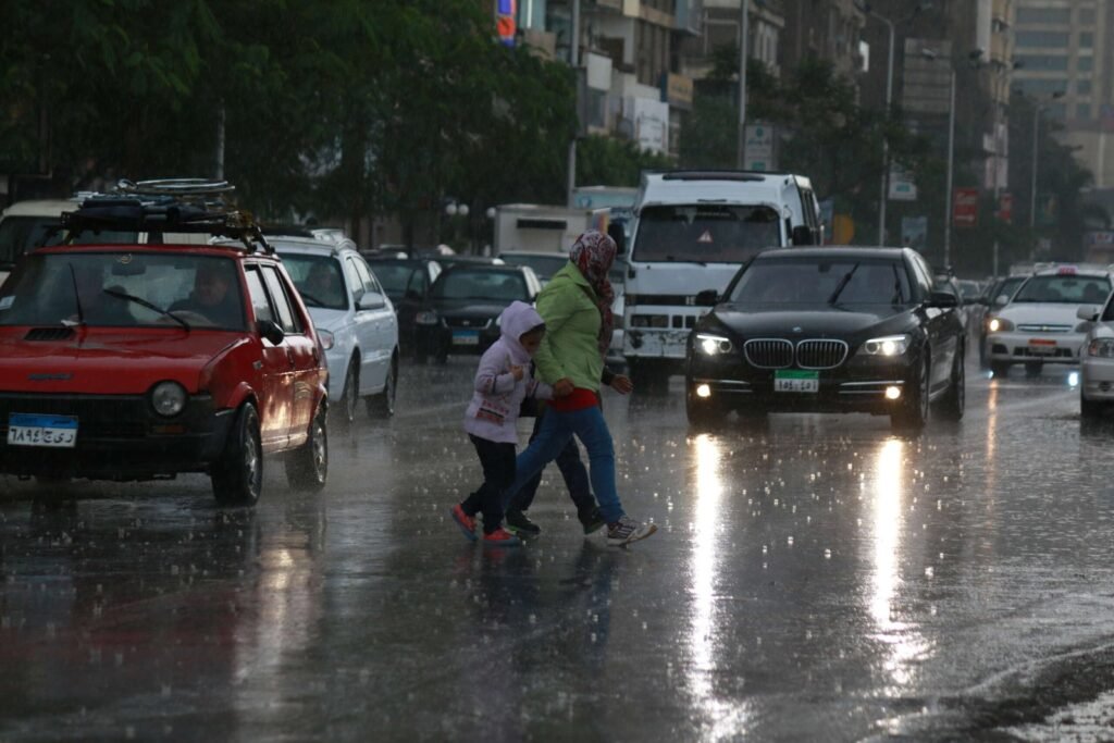 Family Crossing the Street on a Rainy Day in Cairo 2