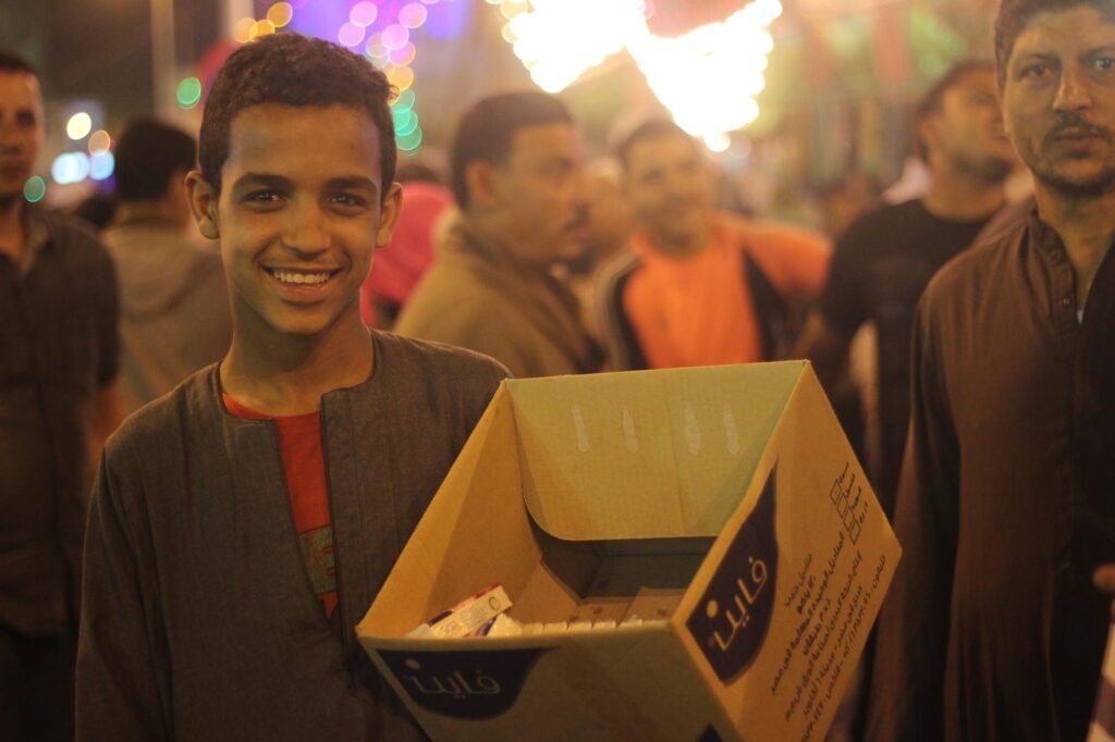 Young Tissue Vendor at a Traditional Mawlid – Cairo, Egypt