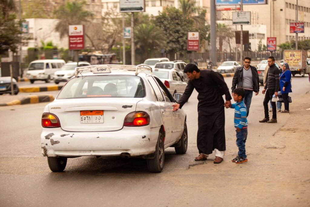 Man and Child Approaching Taxi in Cairo