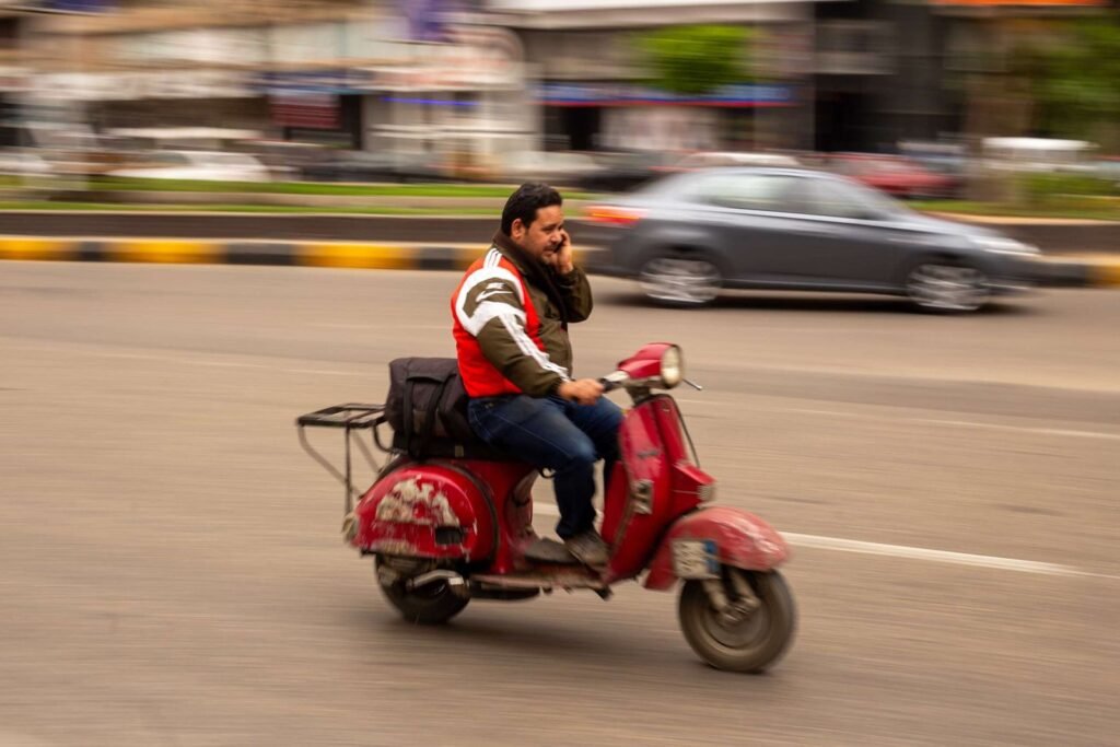 Man on Vintage Red Scooter in Cairo