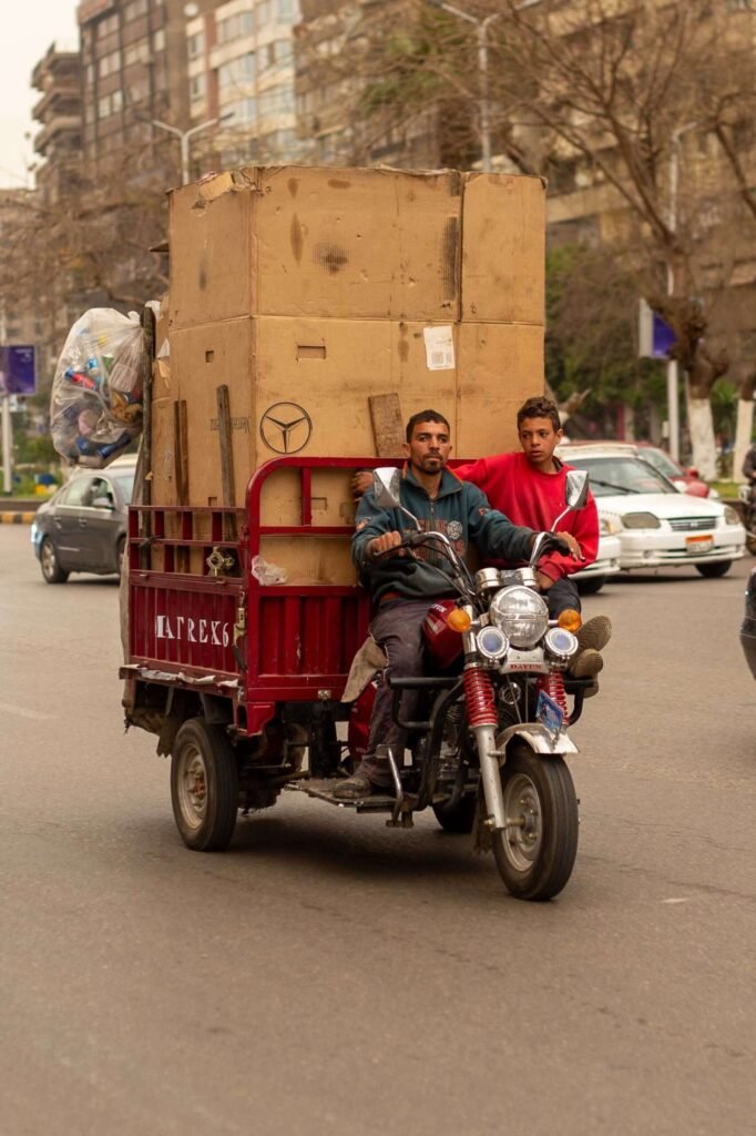 Men Transporting Cardboard Boxes on Motor Tricycle in Cairo 2