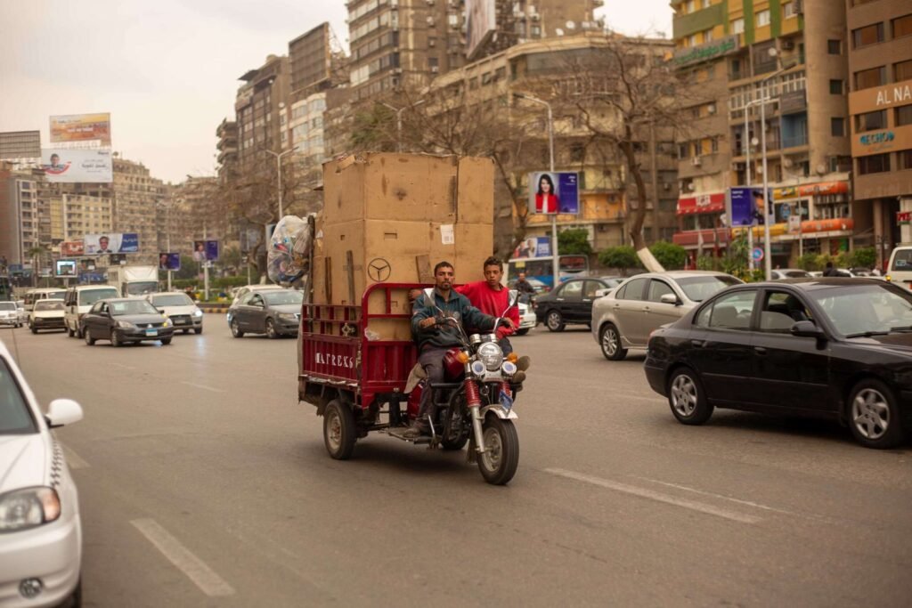 Men Transporting Cardboard Boxes on Motor Tricycle in Cairo