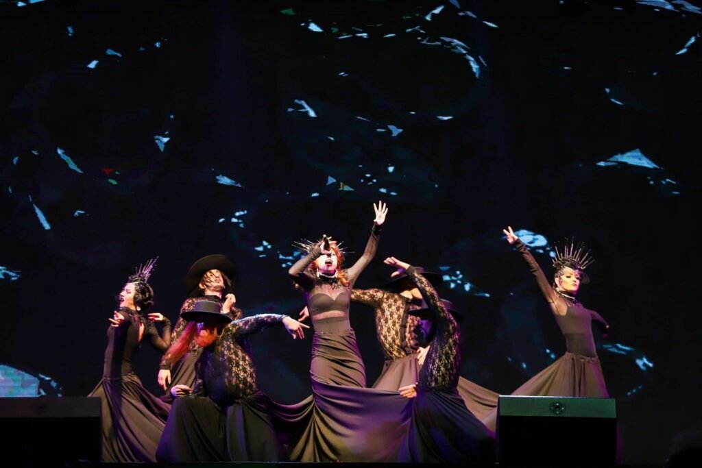 A girl singing in front of a Christmas tree 2